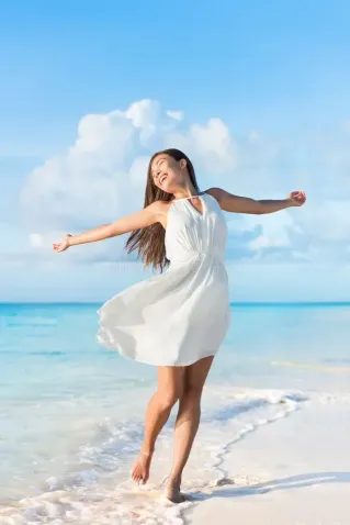 A young female dancer performs an elegant contemporary dance pose in a studio setting.